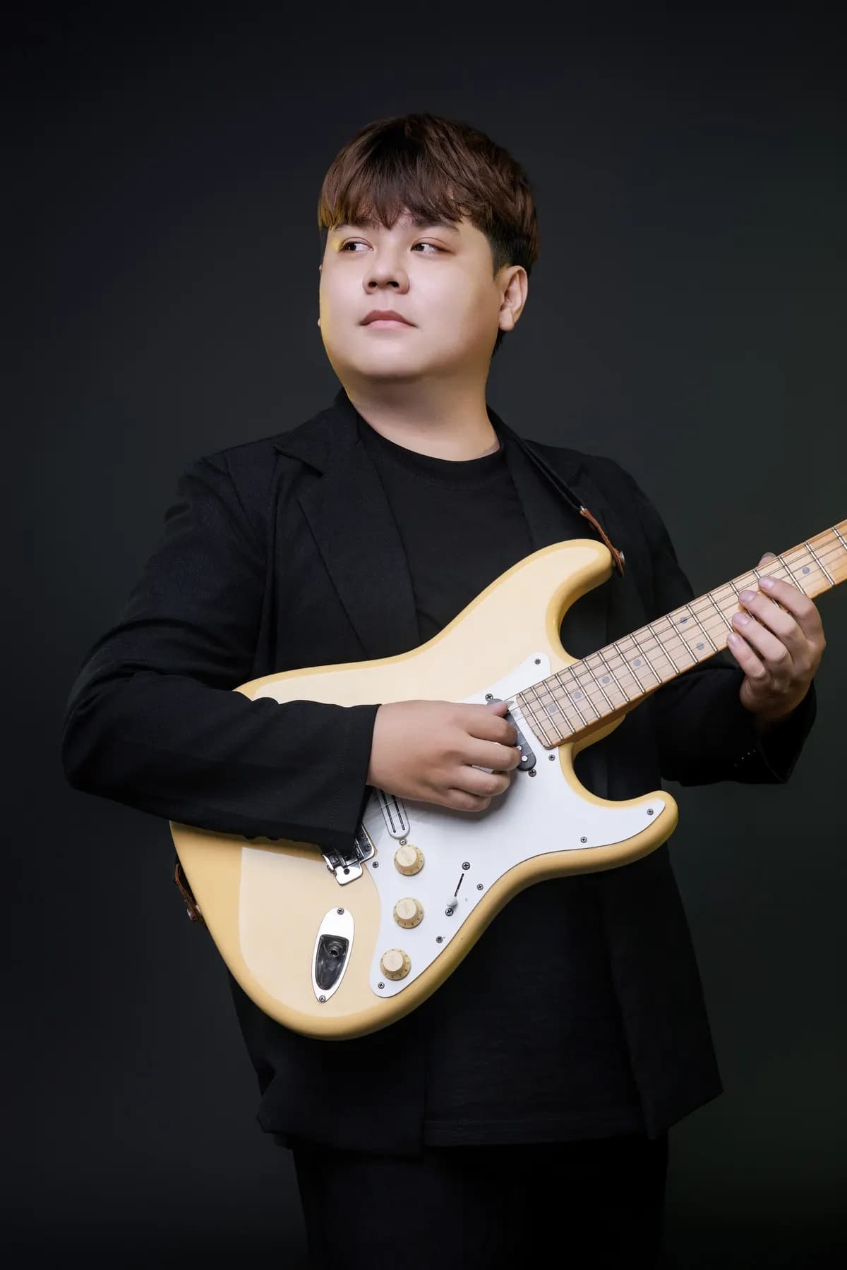 Guitarist with a cream electric guitar