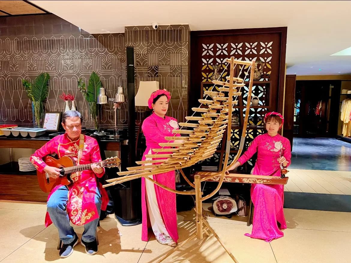 Traditional trio with a bamboo t'rung in a hotel lobby