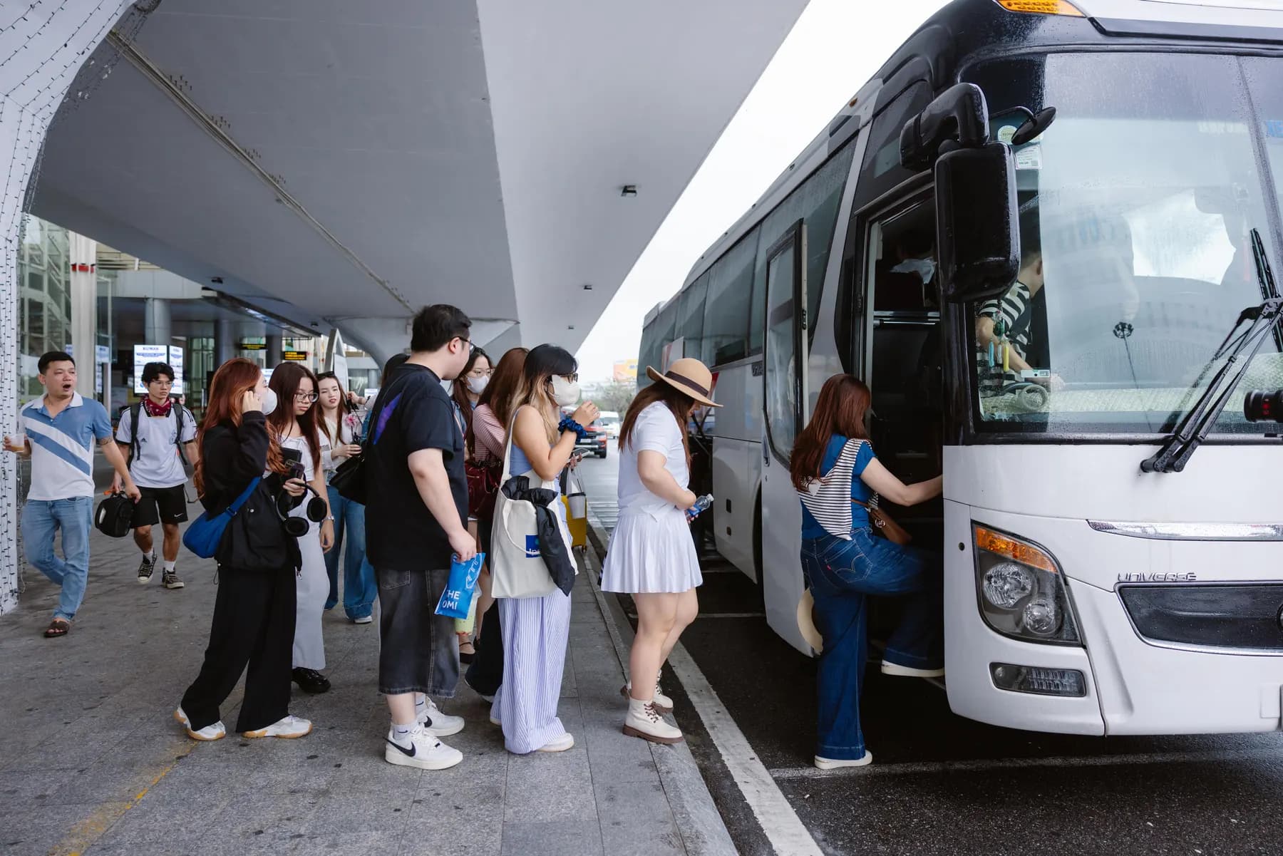 Guests boarding the coach outside the airport terminal