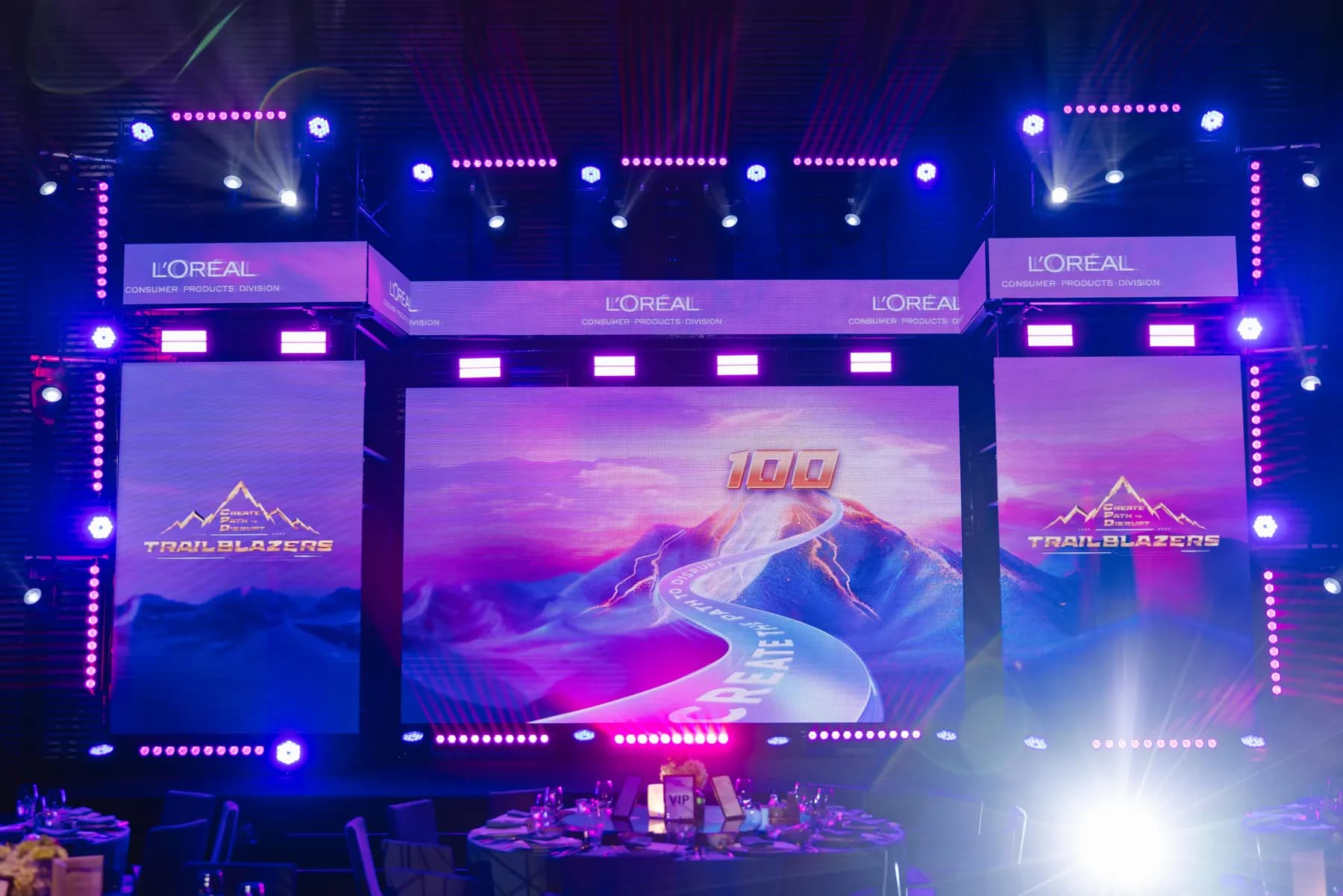 Trailblazers gala stage with three LED screens and a lighting truss