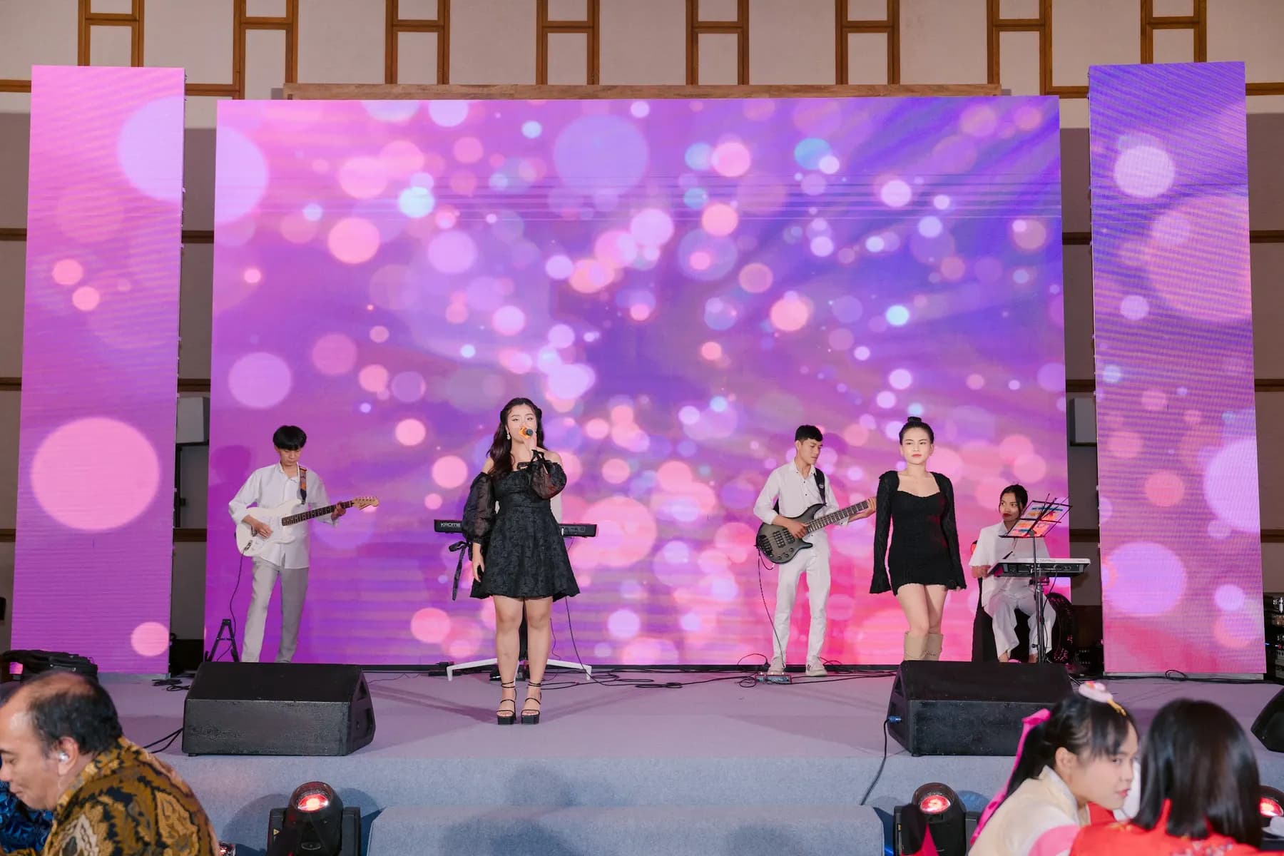 Live band and singers performing in front of the LED wall