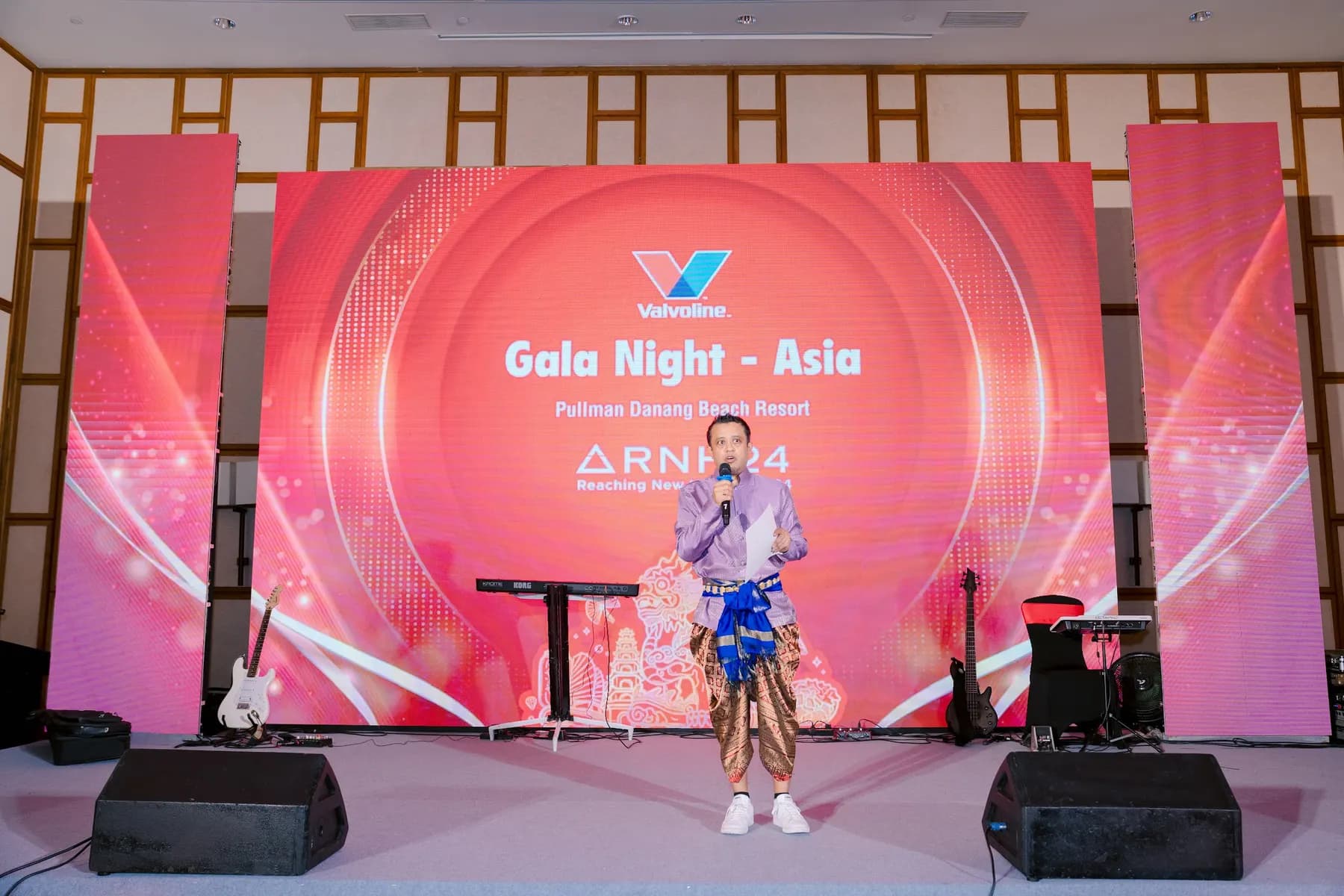 Host on stage in front of the Gala Night LED backdrop