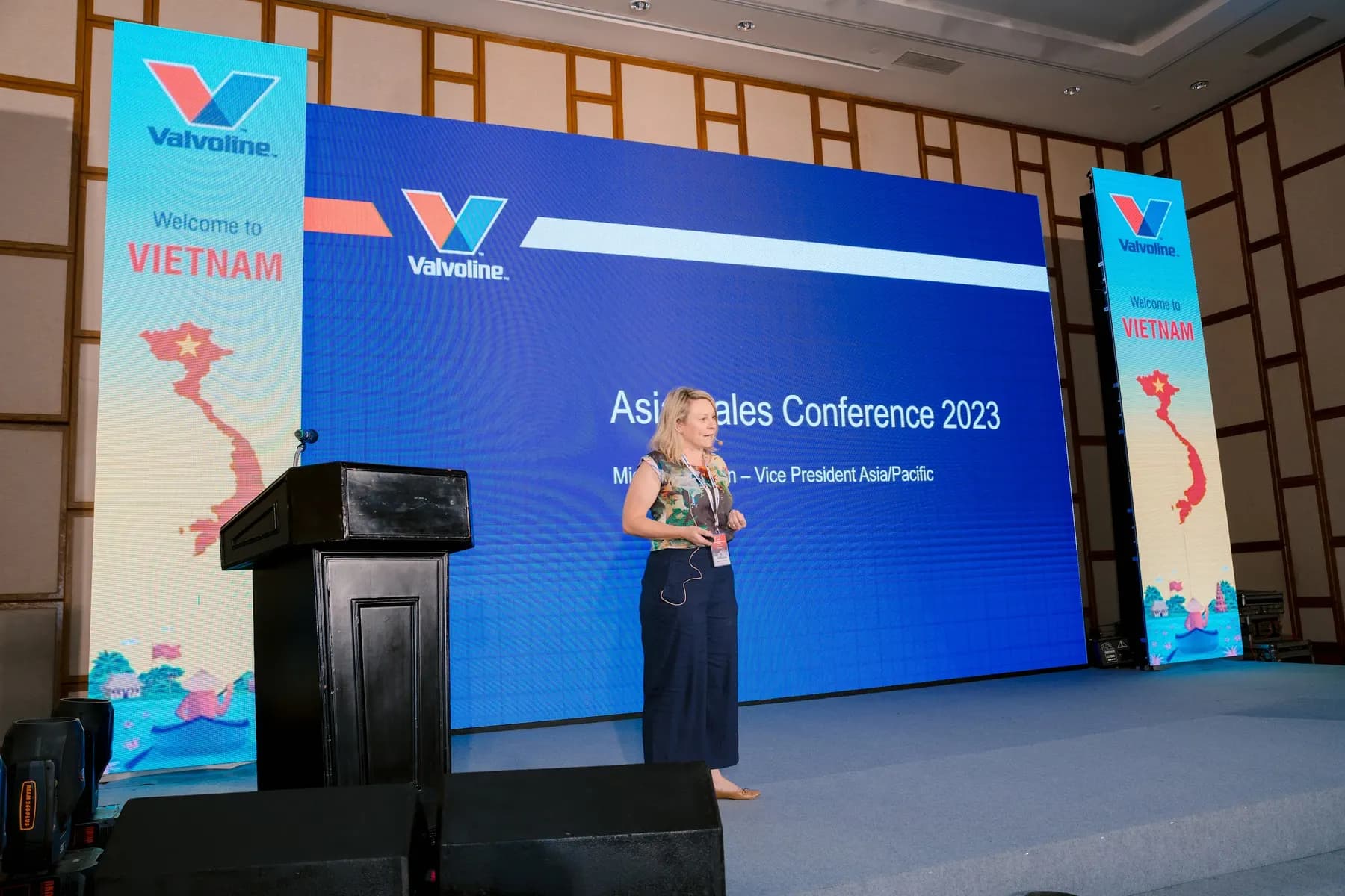 Speaker at the lectern in front of the conference LED wall