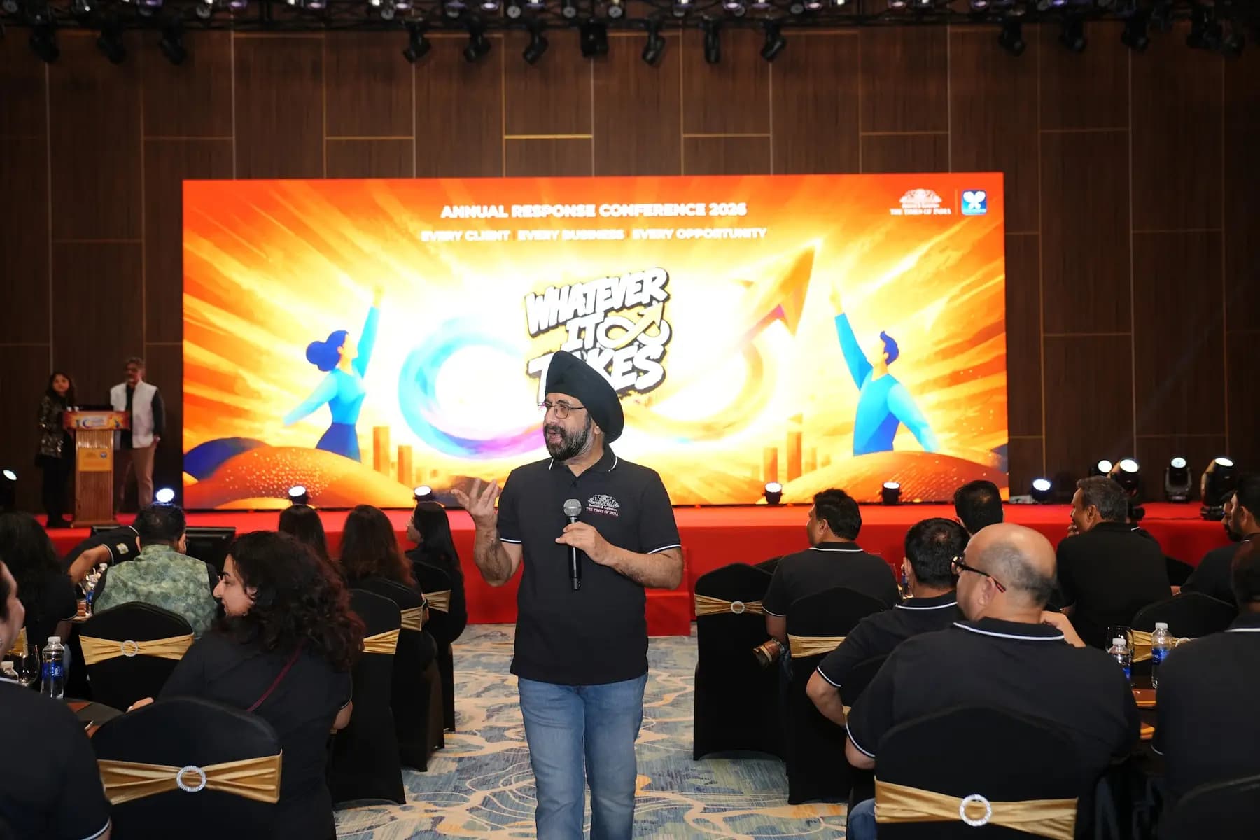 Speaker on stage in front of the LED backdrop