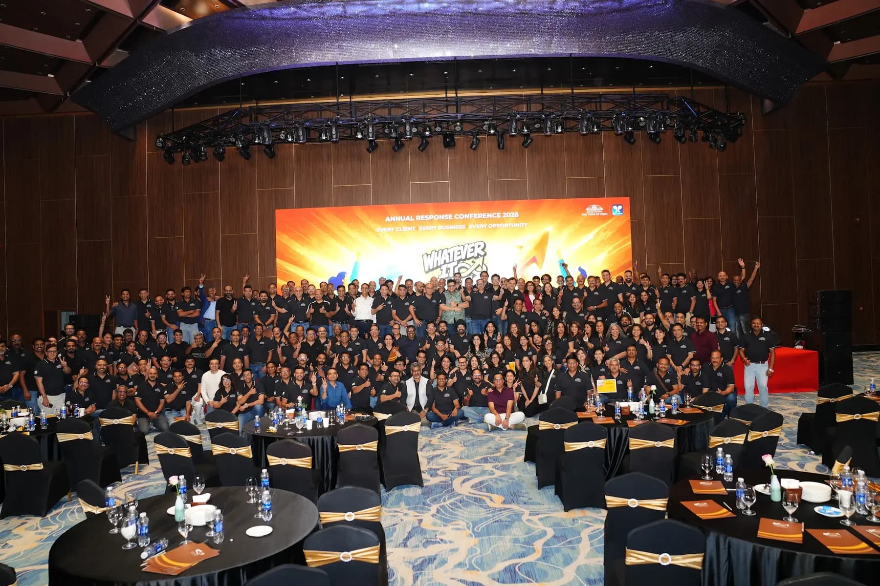 Whole audience posing for a group photo in the ballroom