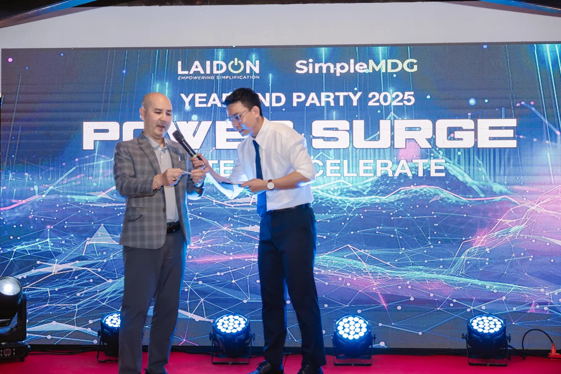 Award handed over on stage in front of the Power Surge LED screen
