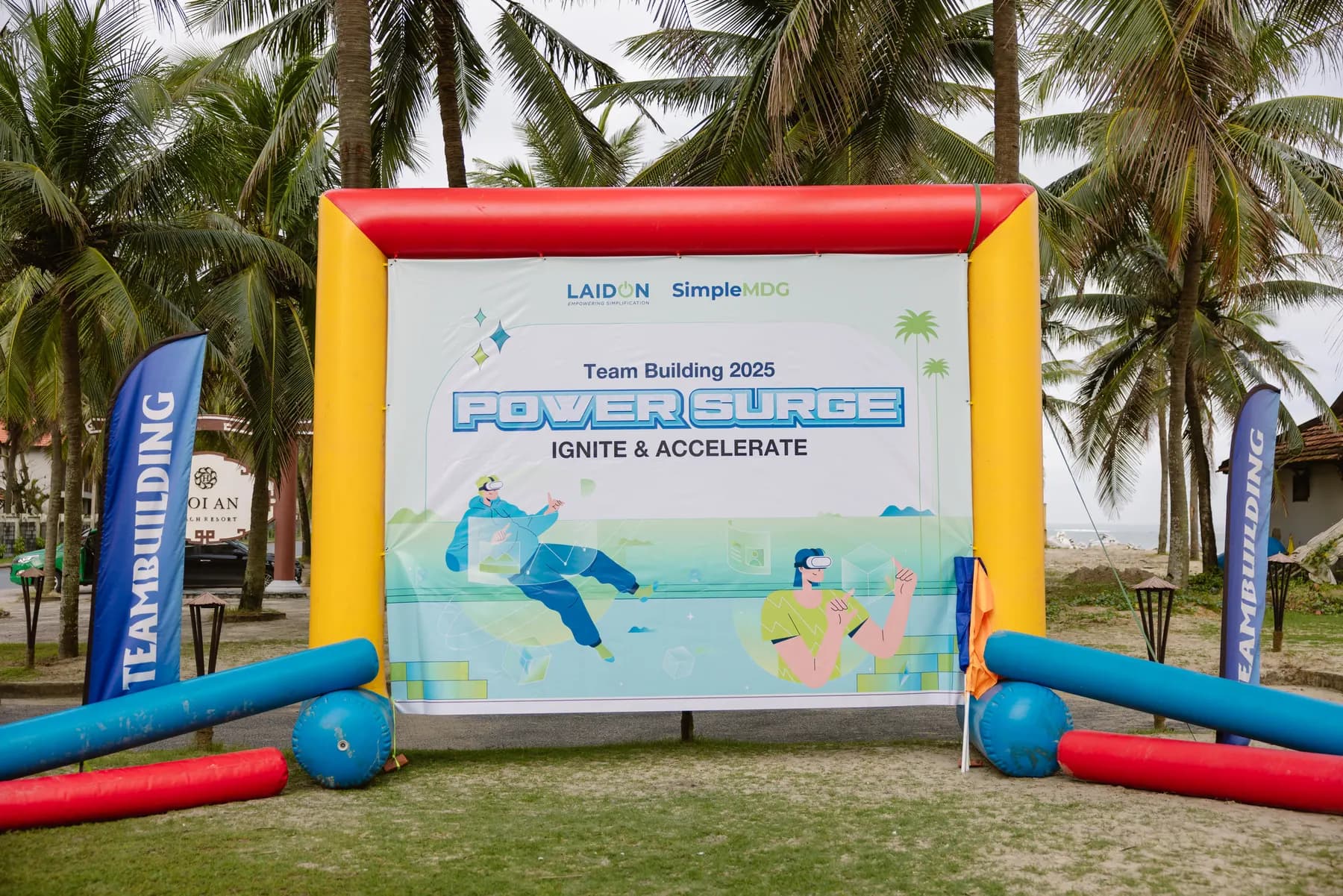 Inflatable Power Surge team building backdrop on the lawn by the beach