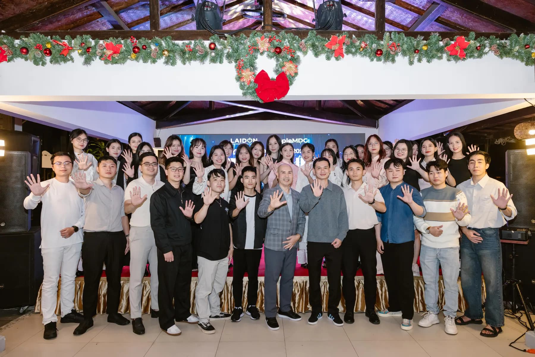 Group photo under Christmas garlands in the riverside party venue