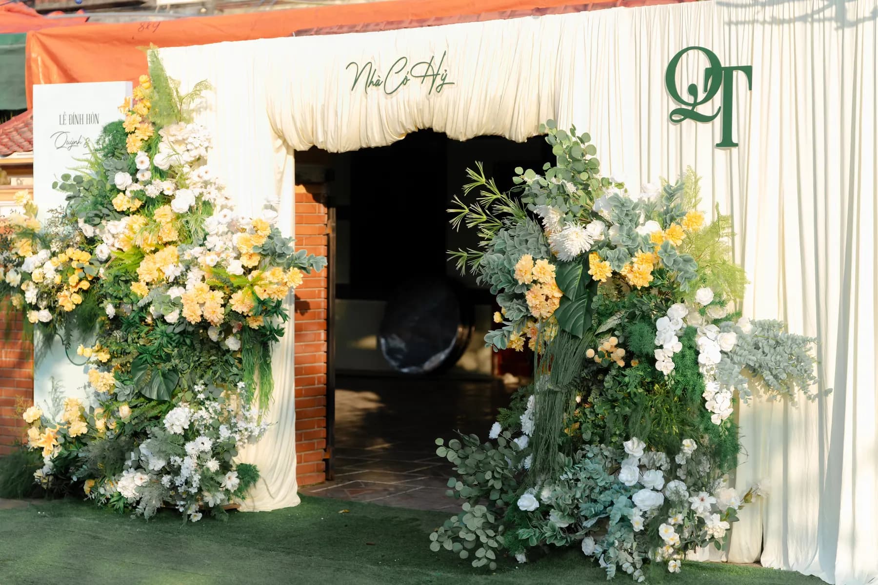 Tent entrance framed with yellow and white flowers