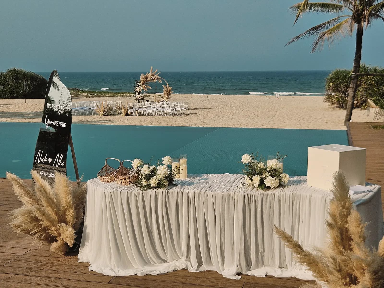 Reception desk beside the pool with pampas grass